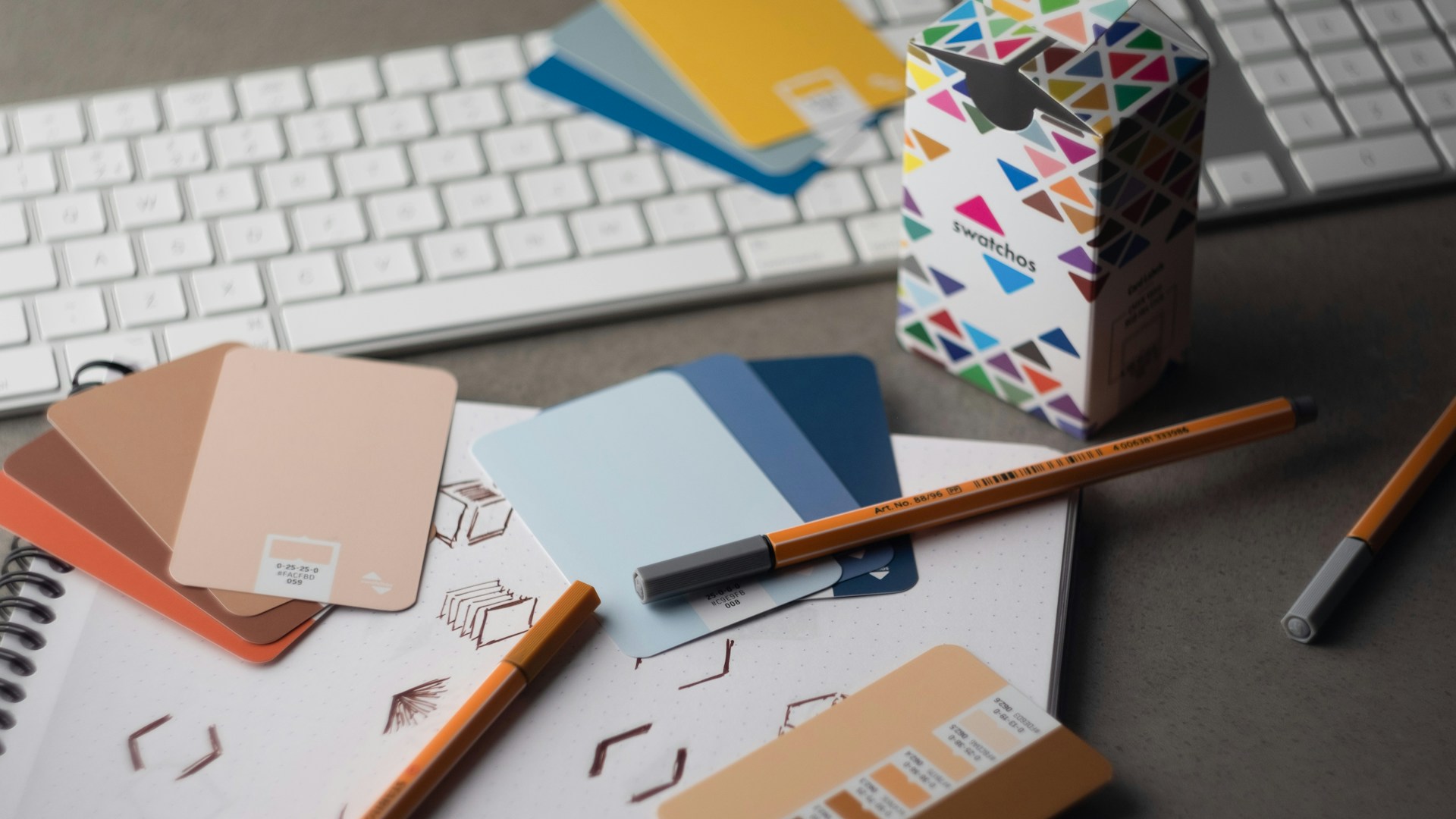 Graphic design workspace with color swatches representing brand consistency across web, social media and print